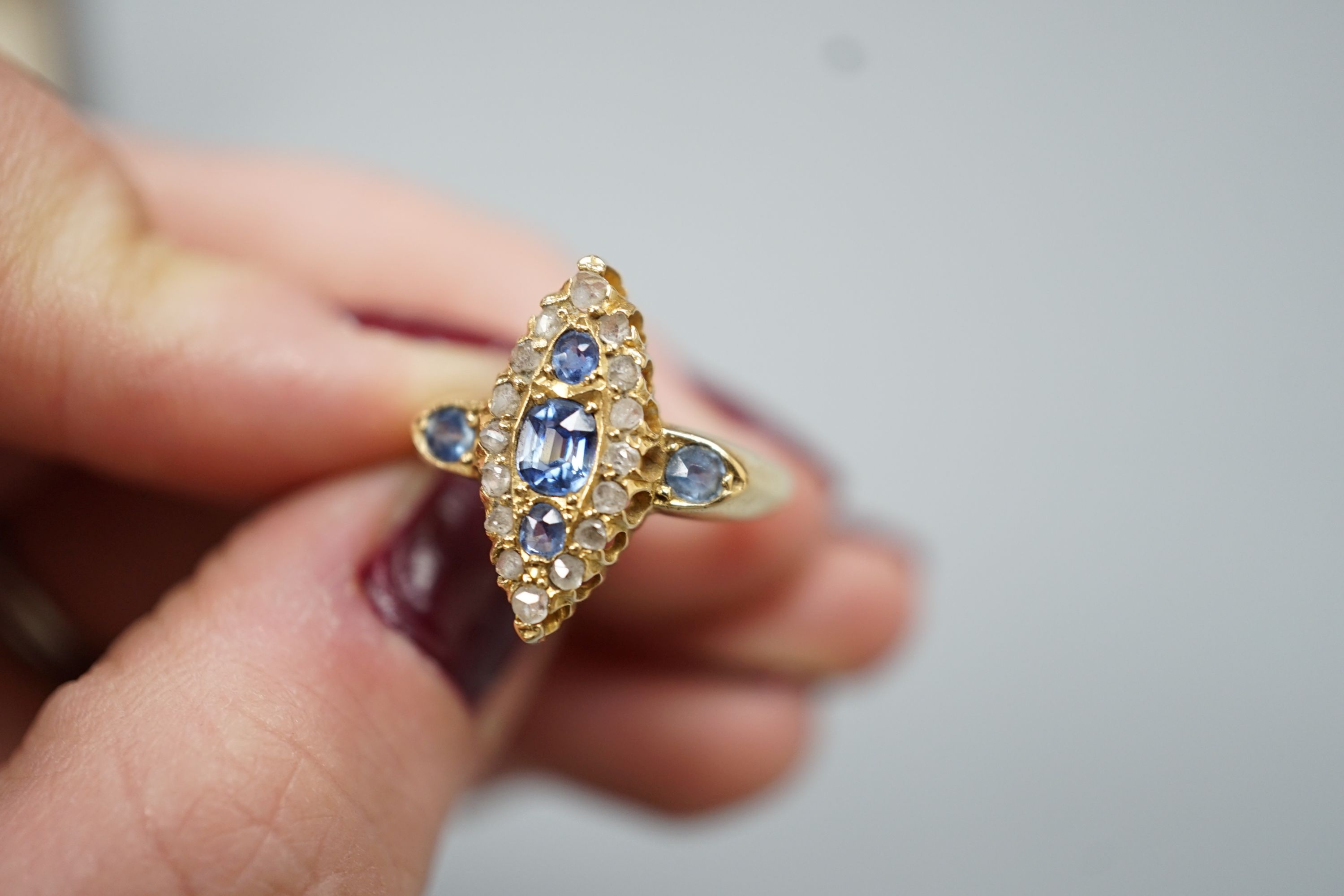 An Edwardian 18ct gold, sapphire and diamond set marquise set cluster ring, size K, gross weight 3.2 grams